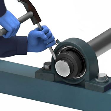 using a hammer and punch to lock a bearing collar onto a shaft-1
